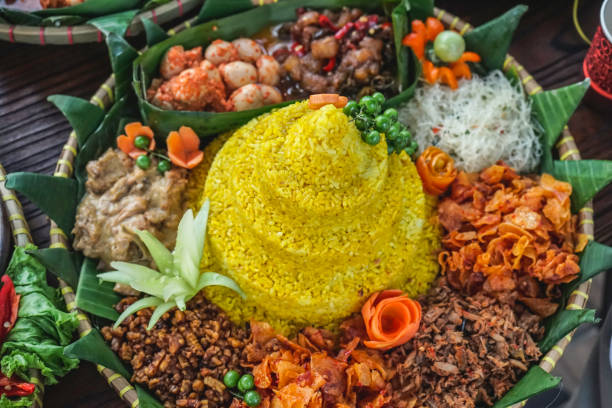 indonesian yellow rice - nasi kuning khas indonesia - tumpeng - tumpeng potret stok, foto, & gambar bebas royalti